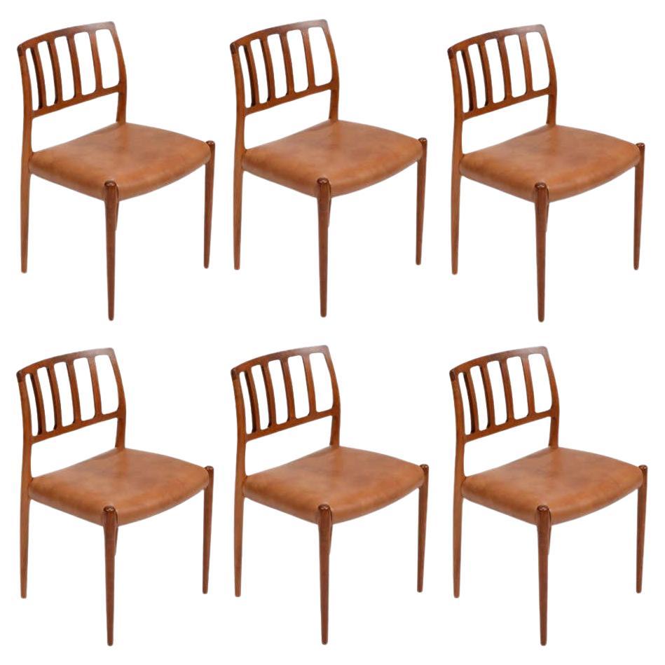 Six Niels Otto Møller Model 83 teak and brown leather dining chairs